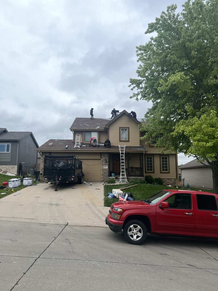 Roofing crew working on a residential roof replacement project.