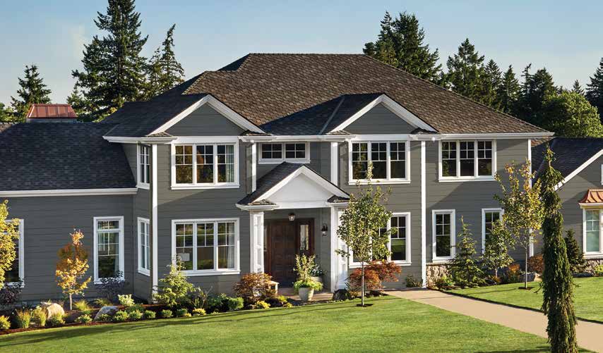 Finished two-story home with gray horizontal siding, white trim, multiple gables, and landscaped front lawn in ASCEND manufacturer photography.