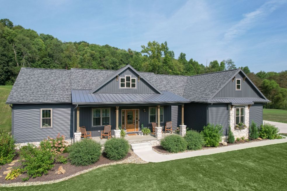 Finished single-story home with ProVia CedarMAX board and batten in the gables and HeartTech horizontal vinyl siding in Nautica, with a front porch and landscaped lawn.